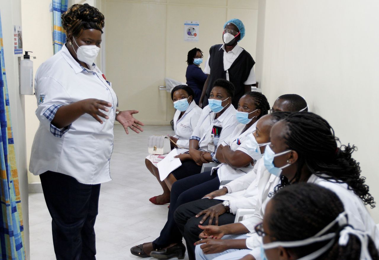 FILE PHOTO: A health worker talks to her colleagues as they prepare to receive the AstraZeneca/Oxford vaccine under the COVAX scheme against coronavirus disease (COVID-19) at the Kenyatta National Hospital in Nairobi, Kenya March 5, 2021. REUTERS/Monicah Mwangi