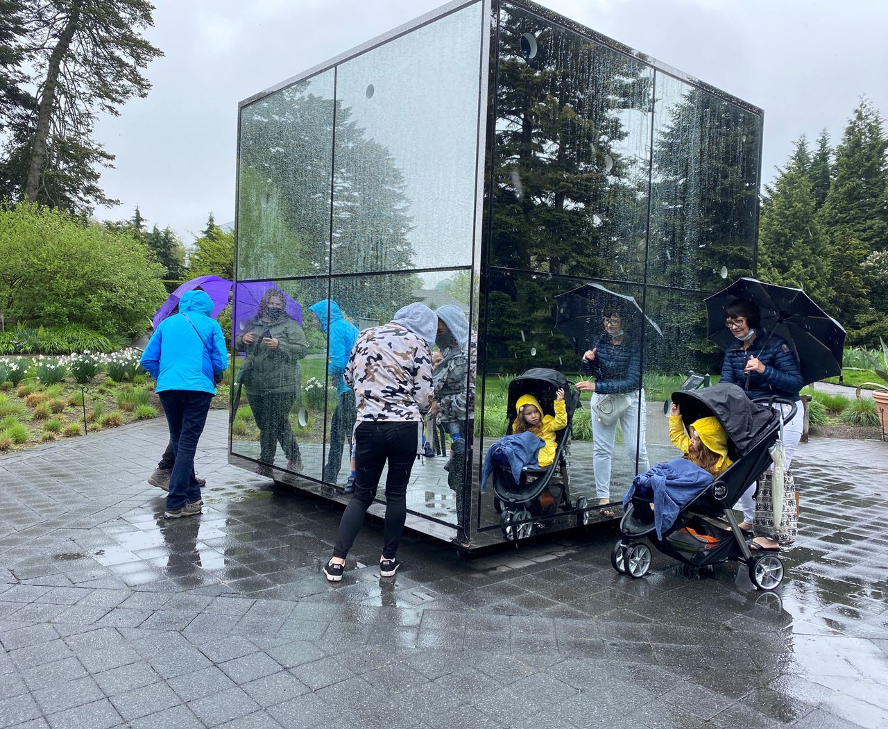 People interact near an exhibit at the KUSAMA: Cosmic Nature event at the New York Botanical Garden, in New York City, New York, U.S., May 5, 2021. REUTERS/Roselle Chen