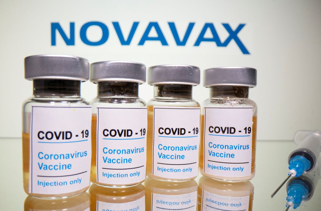 FILE PHOTO: Vials with a sticker reading, "COVID-19 / Coronavirus vaccine / Injection only" and a medical syringe are seen in front of a displayed Novavax logo in this illustration taken October 31, 2020. REUTERS/Dado Ruvic/Illustration/File Photo