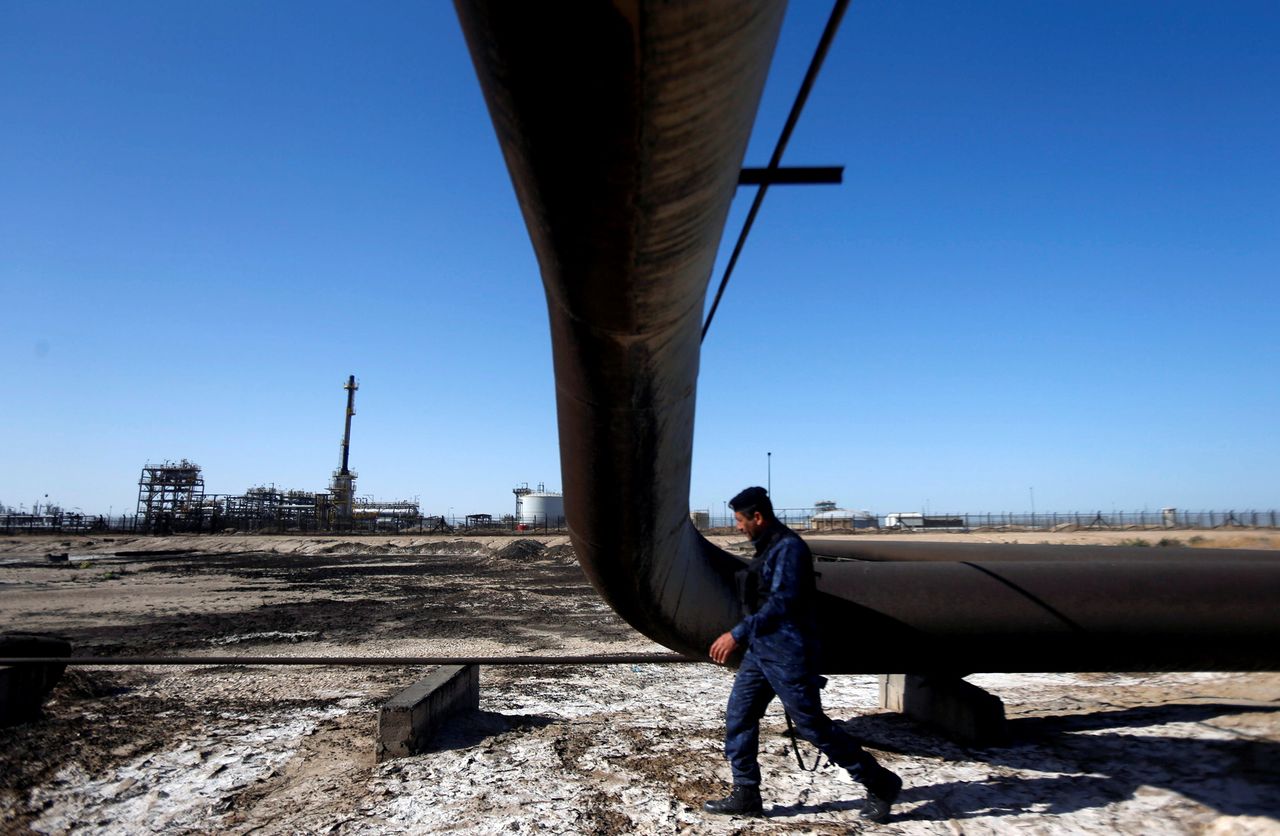 FILE PHOTO: A policeman walks at West Qurna-1 oil field, which is operated by ExxonMobil, in Basra, Iraq, January 9, 2020. REUTERS/Essam al-Sudani/File Photo