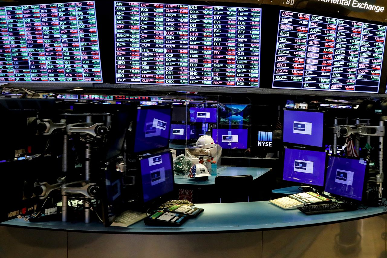 FILE PHOTO: Dividers are seen inside a trading post on the trading floor at the New York Stock Exchange (NYSE), May 22, 2020. REUTERS/Brendan McDermid/File Photo