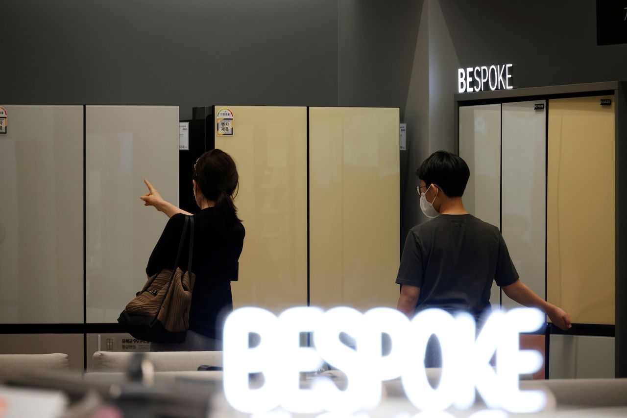 A woman and her son look around Samsung Electronics