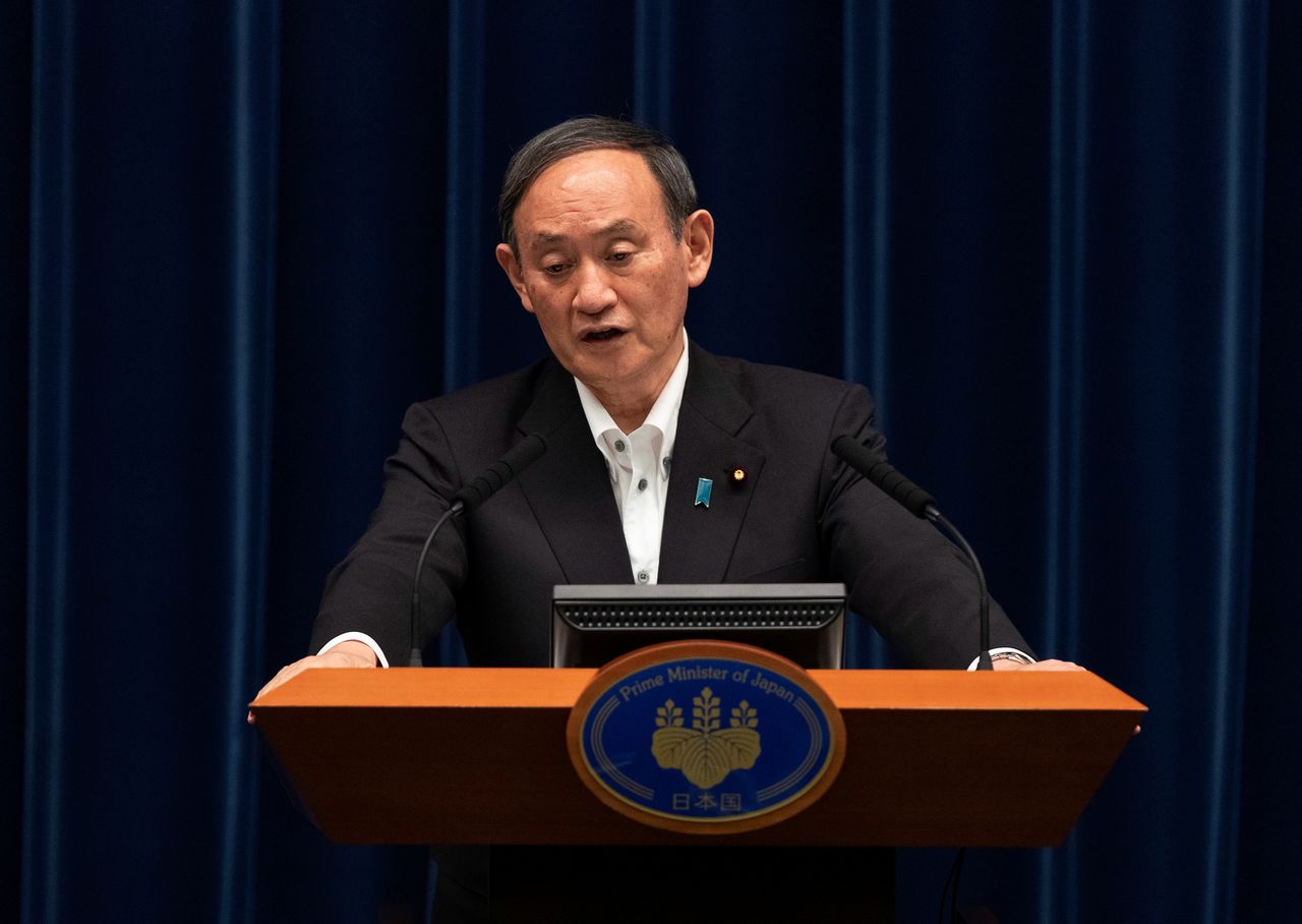 FILE PHOTO: Japanese Prime Minister Yoshihide Suga responds to a reporter’s question after speaking at a news conference in Tokyo, Japan, May 7, 2021. Hiro Komae/Pool via REUTERS