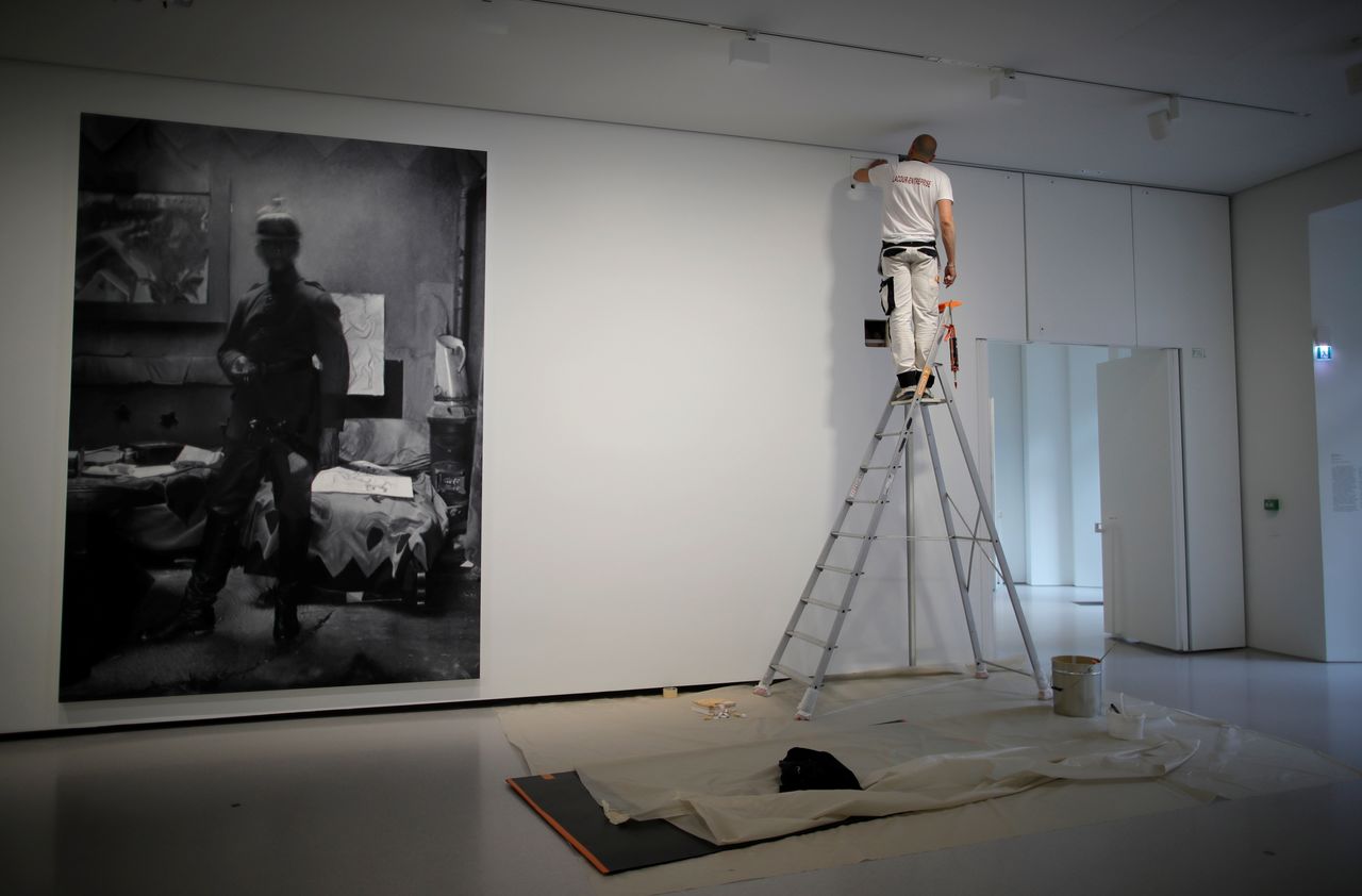 An employee works next to the artwork "Untitled (Ernst Ludwig Kirchner), 2010" by artist Rudolf Stingel in Gallery 4 during a press visit at the Bourse de Commerce - Pinault Collection contemporary art museum in Paris, France, May 14, 2021. REUTERS/Sarah Meyssonnier