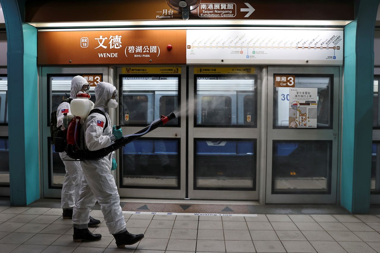 Soldiers in protective suits disinfect a metro station following a surge of coronavirus disease (COVID-19) infections in Taipei, Taiwan May 19, 2021. REUTERS/Ann Wang