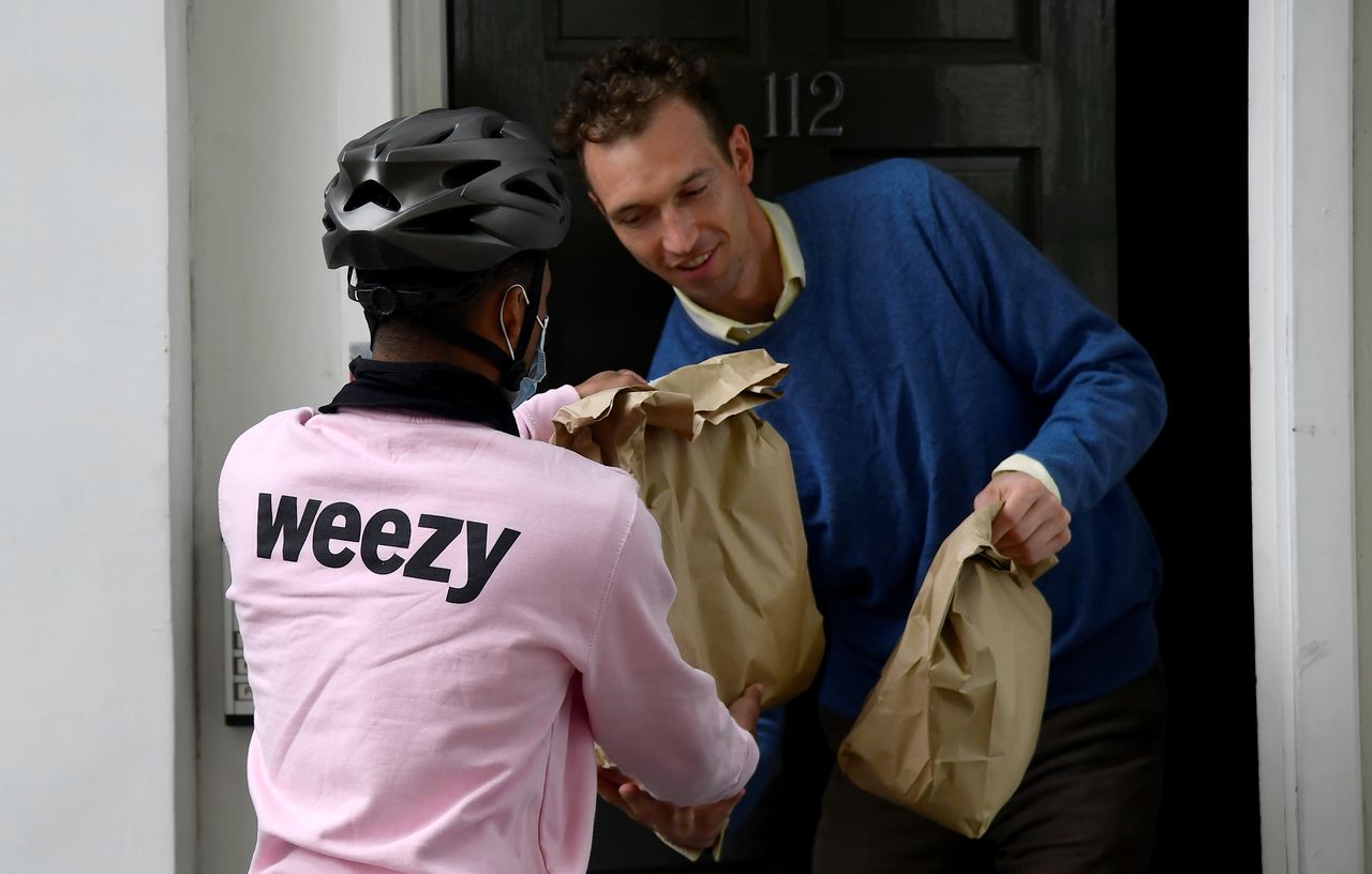 A rider from online supermarket Weezy delivers an order amidst the expansion of rapid grocery delivery firms, Pimlico, London, Britain, May 12, 2021. Picture taken May 12, 2021. REUTERS/Toby Melville
