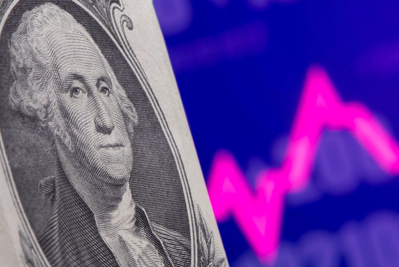 FILE PHOTO: A U.S. one dollar banknote is seen in front of displayed stock graph in this illustration taken May 7, 2021. REUTERS/Dado Ruvic/Illustration