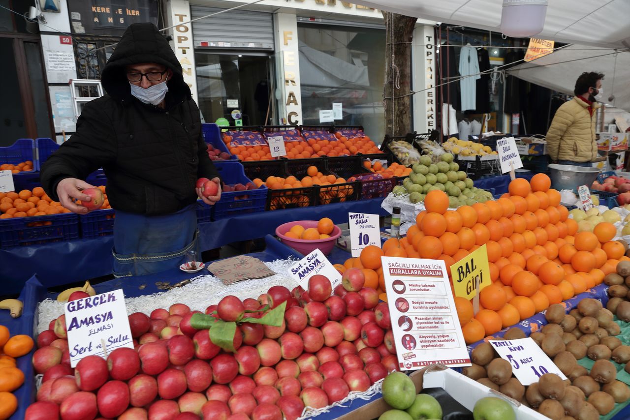 FILE PHOTO: Seref Geyik, a 53-year old seller, waits for customers at his stall at a local market in Fatih district in Istanbul, Turkey January 13, 2021. REUTERS/Murad Sezer