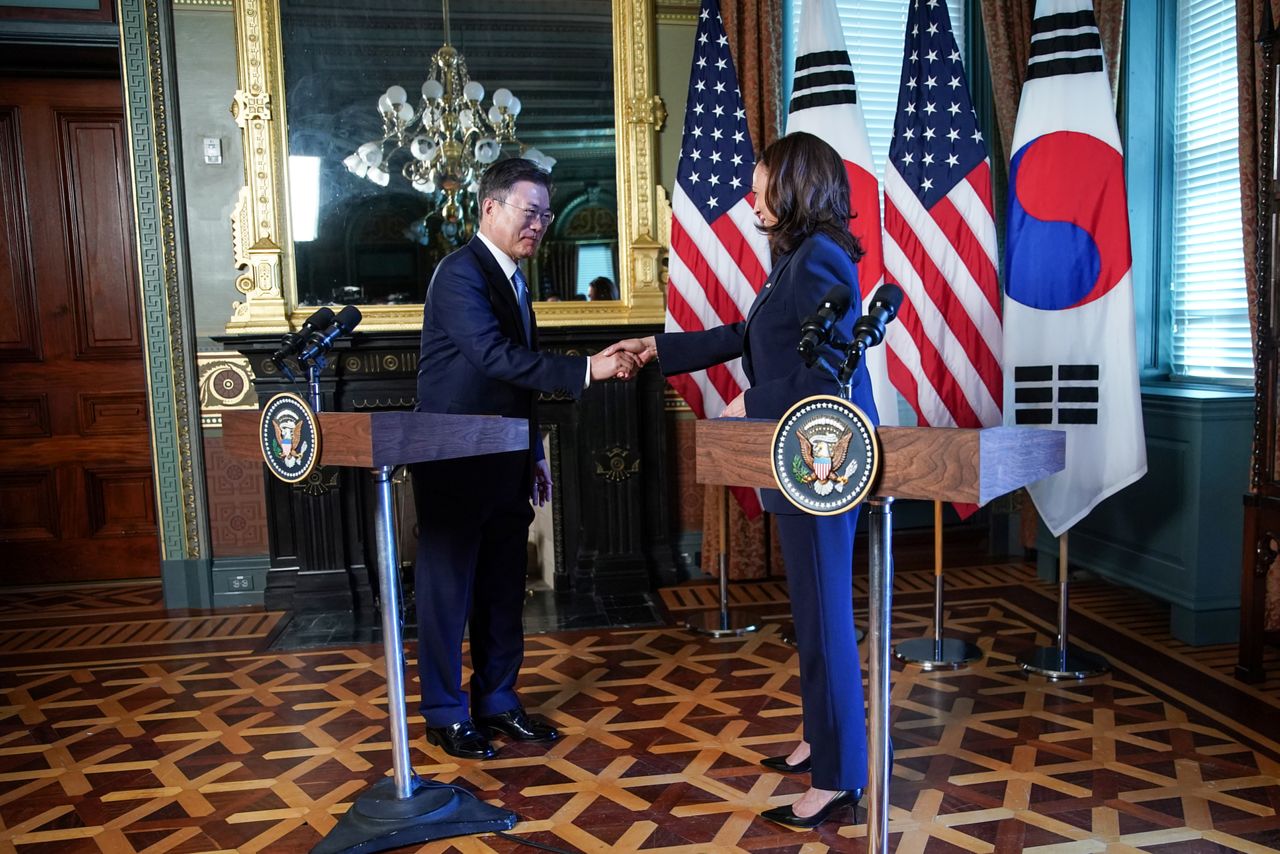 U.S. Vice President Kamala Harris and South Korean President Moon Jae-in shake hands before participating in a bilateral meeting at the Eisenhower Executive Office Building near the White House in Washington, U.S., May 21, 2021. REUTERS/Sarah Silbiger