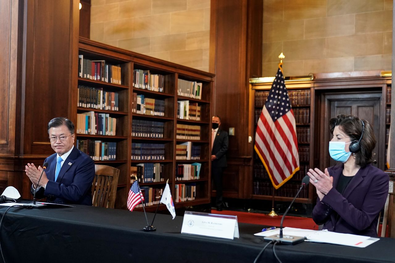 South Korean President Moon Jae-in speaks as U.S. Secretary of Commerce Gina Raimondo listens during a CEO meeting at the Department of Commerce in Washington, U.S., May 21, 2021. REUTERS/Joshua Roberts