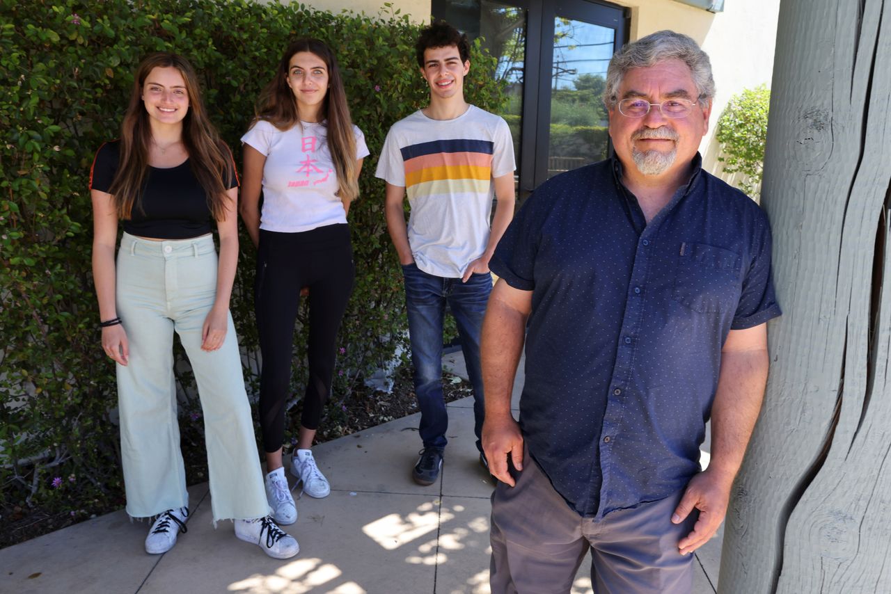 Rabbi Evan Goodman, 56, poses for a photo with students Tyler Barth, 21, Romi Benasuly, 20, and Lian Benasuly, 20, near the University of California, Santa Barbara (UCSB) campus in Isla Vista, California, U.S., May 24, 2021. REUTERS/Lucy Nicholson