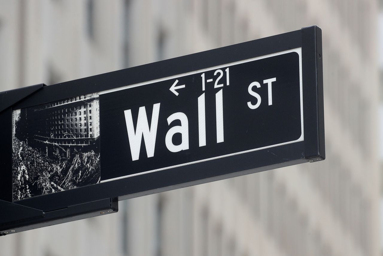 FILE PHOTO: The Wall St. sign is seen near the New York Stock Exchange (NYSE) in New York City, U.S., May 4, 2021. REUTERS/Brendan McDermid