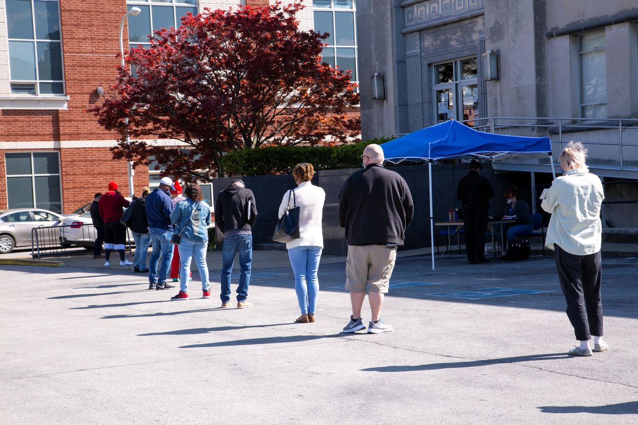 FILE PHOTO: People wait in a line outside a newly reopened career center for in-person appointments in Louisville, Kentucky, U.S., April 15, 2021. REUTERS/Amira Karaoud