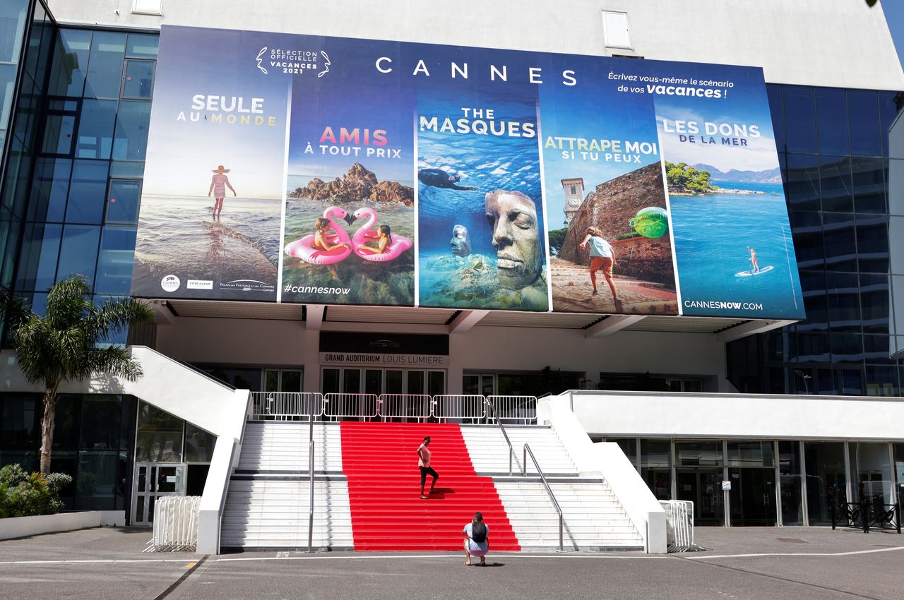 People stand on the red carpet of the Festival palace in Cannes as the French Riviera prepares for the 2021 edition of the Cannes Film Festival which will take place next July, in France, June 3, 2021. REUTERS/Eric Gaillard