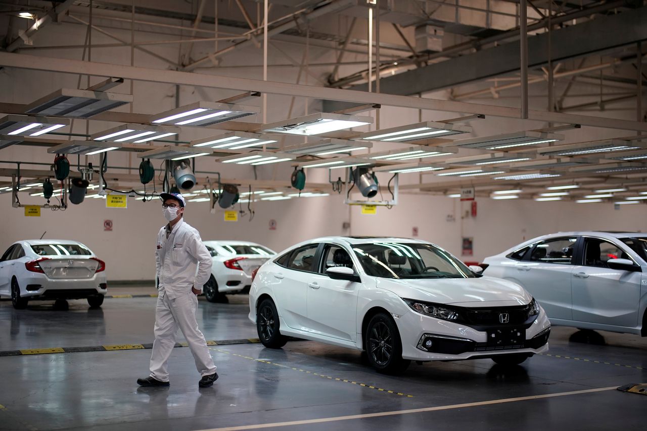 FILE PHOTO: An employee is seen on a production line inside a Dongfeng Honda factory after lockdown measures in Wuhan, the capital of Hubei province and China