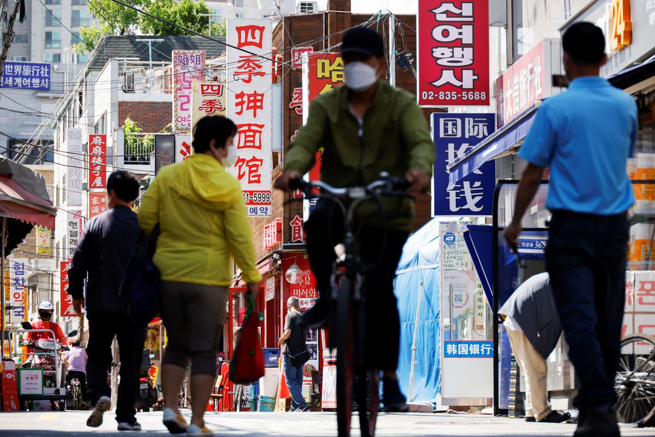 Residents walk in Seoul