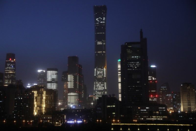 FILE PHOTO: Buildings in the Central Business District (CBD) are seen lit up during the night in Beijing, China April 15, 2021. Picture taken April 15, 2021. REUTERS/Tingshu Wang