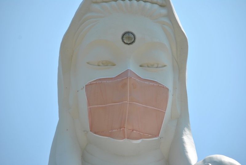 A mask is seen placed on a 57-metre-high statue of Buddhist goddess Kannon to pray for the end of the coronavirus disease (COVID-19) pandemic at Houkokuji Aizu Betsuin in Aizuwakamatsu, Fukushima Prefecture, Japan in this handout photo taken on June 15 2021. Picture taken on June 15, 2021. Houkokuji Aizu Betsuin/Handout via REUTERS ATTENTION EDITORS - THIS IMAGE HAS BEEN SUPPLIED BY A THIRD PARTY. NO RESALES. NO ARCHIVES. MANDATORY CREDIT