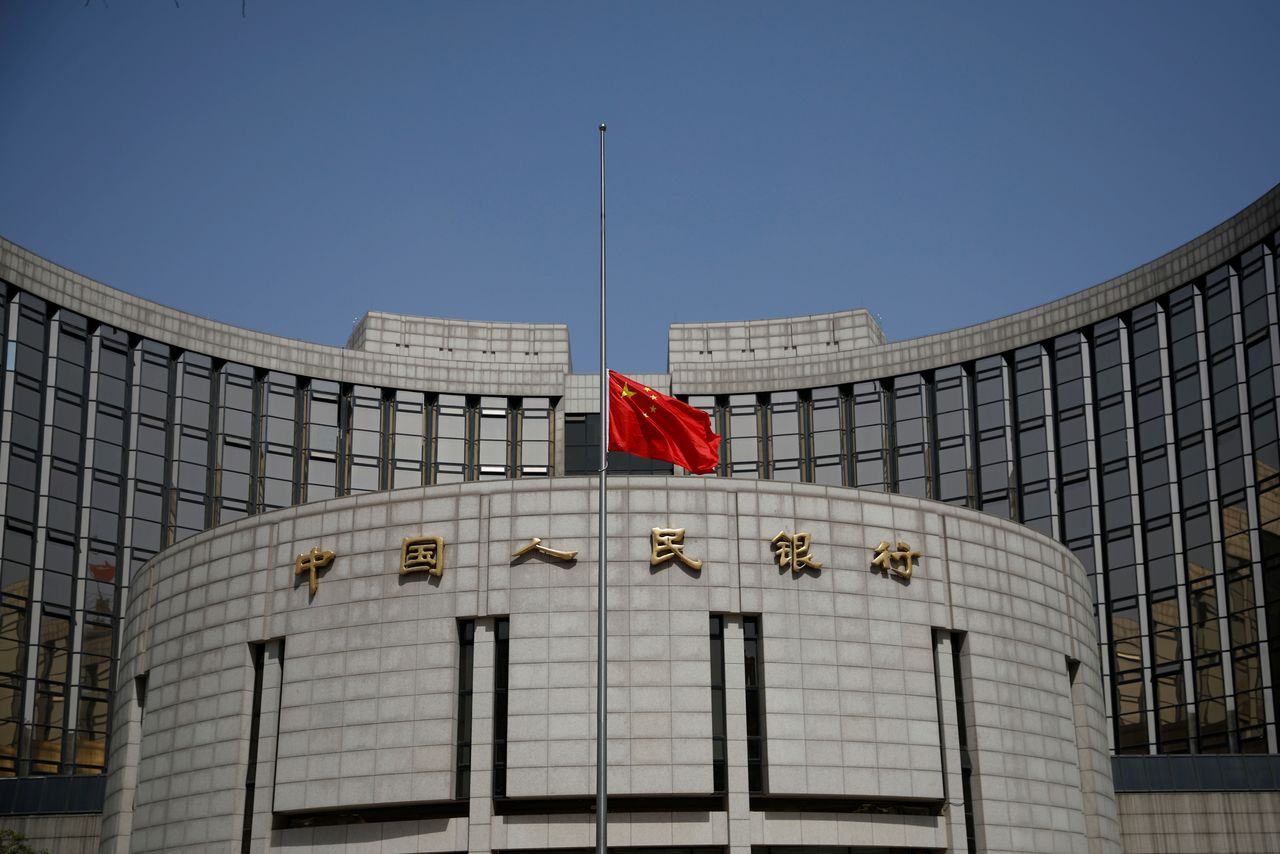 The Chinese national flag flies at half-mast at the headquarters of the People