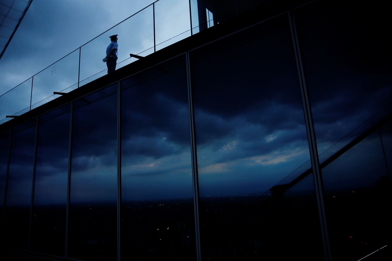 A guard stands on Shibuya Sky, the observation deck of Shibuya Scramble Square, during sunset in Tokyo, Japan, June 1, 2021. REUTERS/Kim Kyung-Hoon