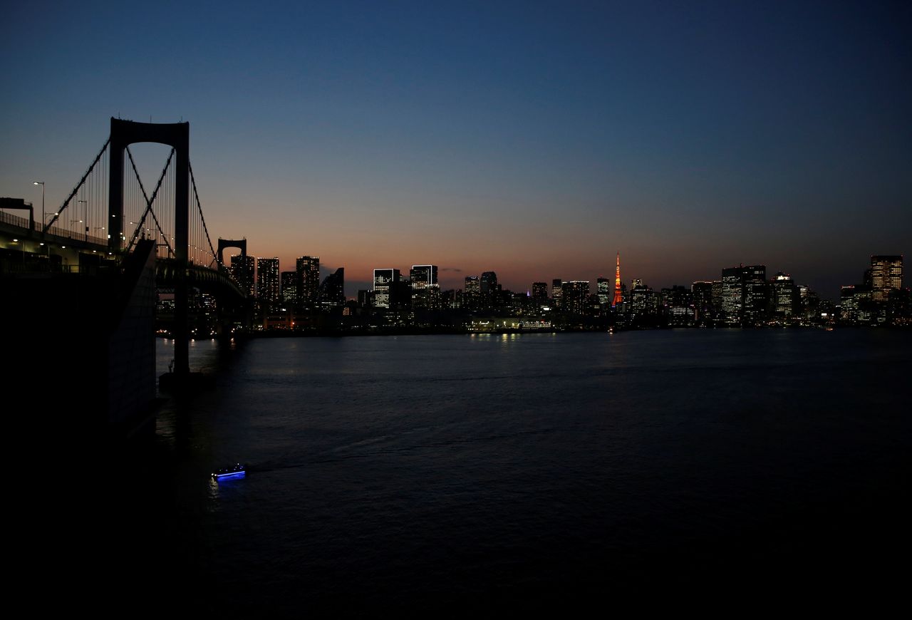 The Rainbow Bridge and buildings are pictured during sunset in Tokyo, Japan, April 7, 2021. REUTERS/Kim Kyung-Hoon