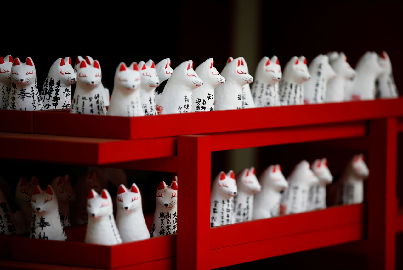 Miniature fox figures bearing worshiper