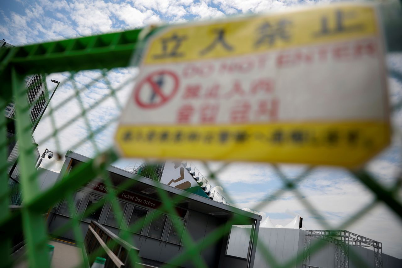 FILE PHOTO: Ticket box office is seen through a fence in preparation for the Tokyo 2020 Olympic Games that have been postponed to 2021 due to the coronavirus disease (COVID-19) outbreak, at Ariake Urban Sports Park in Tokyo, Japan June 22, 2021. REUTERS/Issei Kato