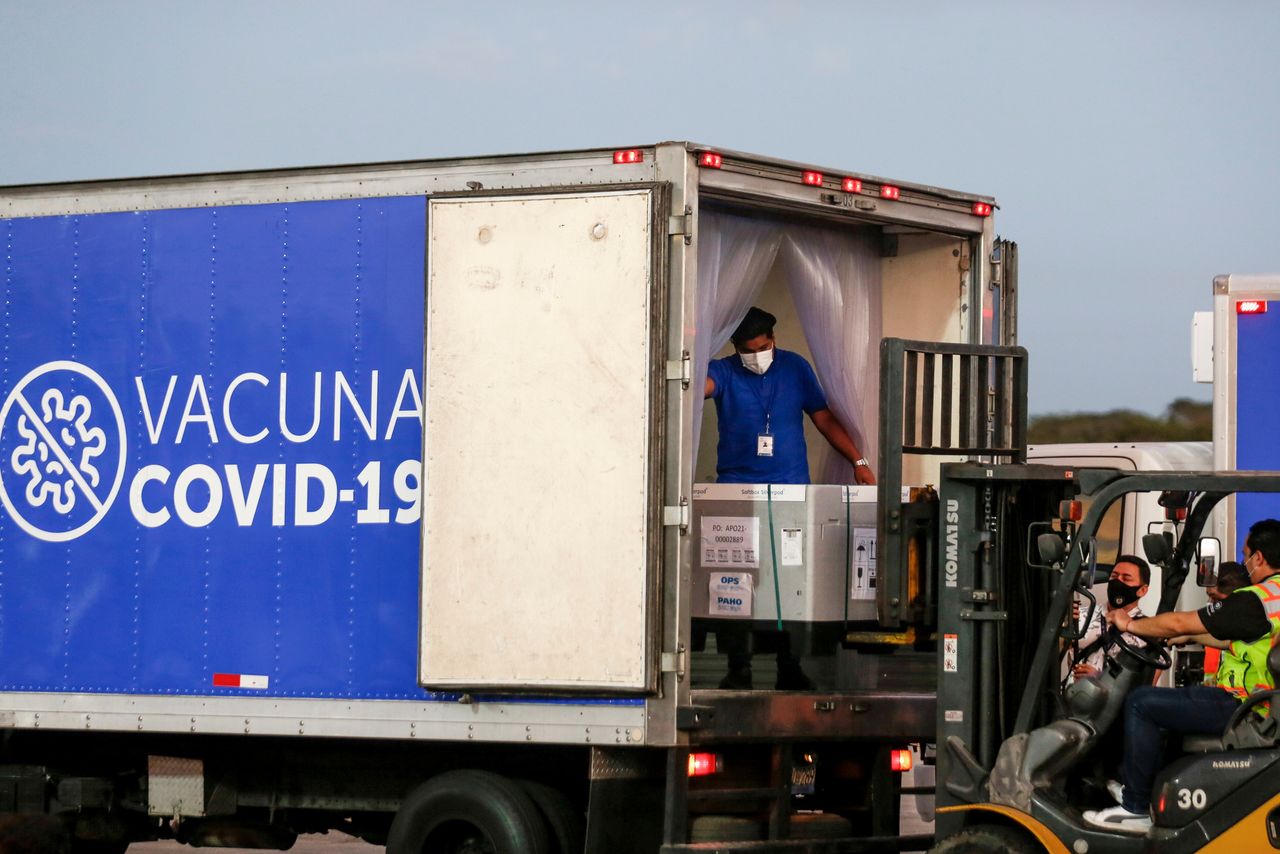 FILE PHOTO: Containers of AstraZeneca (SKBio Corea) vaccines under the COVAX scheme against the coronavirus disease (COVID-19) are loaded onto a truck after arriving at the Mons. Oscar Arnulfo Romero International Airport, in San Luis Talpa, El Salvador March 11, 2021. REUTERS/Jose Cabezas