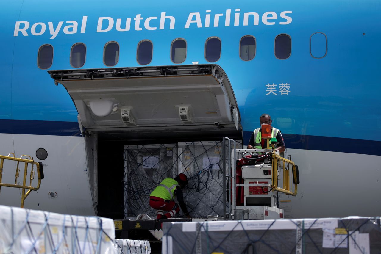 FILE PHOTO: Workers unload a batch of AstraZeneca coronavirus disease (COVID-19) vaccines, delivered under the COVAX scheme, from a KLM Boeing 787 at Benito Juarez International Airport in Mexico City, Mexico May 27, 2021. REUTERS/Henny Romero/File Photo