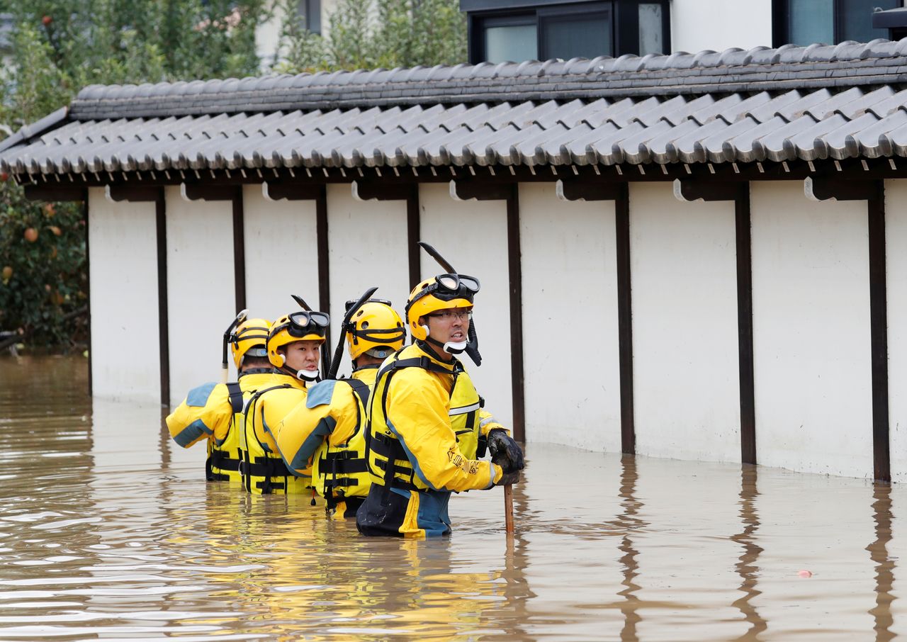 FILE PHOTO: Police search a flooded area in the aftermath of Typhoon Hagibis, which caused severe floods at the Chikuma River in Nagano Prefecture, Japan, October 14, 2019. REUTERS/Kim Kyung-Hoon/File Photo