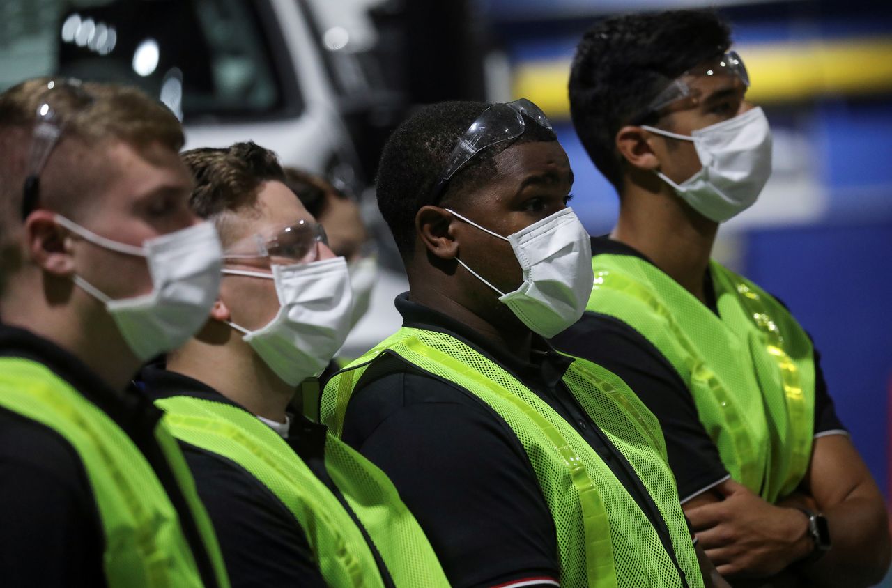 FILE PHOTO: Workers in protective face masks listen as U.S. President Donald Trump delivered a speech during his visit to the Ford Rawsonville Components Plant, which is making ventilators and medical supplies, during the coronavirus disease (COVID-19) pandemic in Ypsilanti, Michigan, U.S., May 21, 2020. REUTERS/Leah Millis