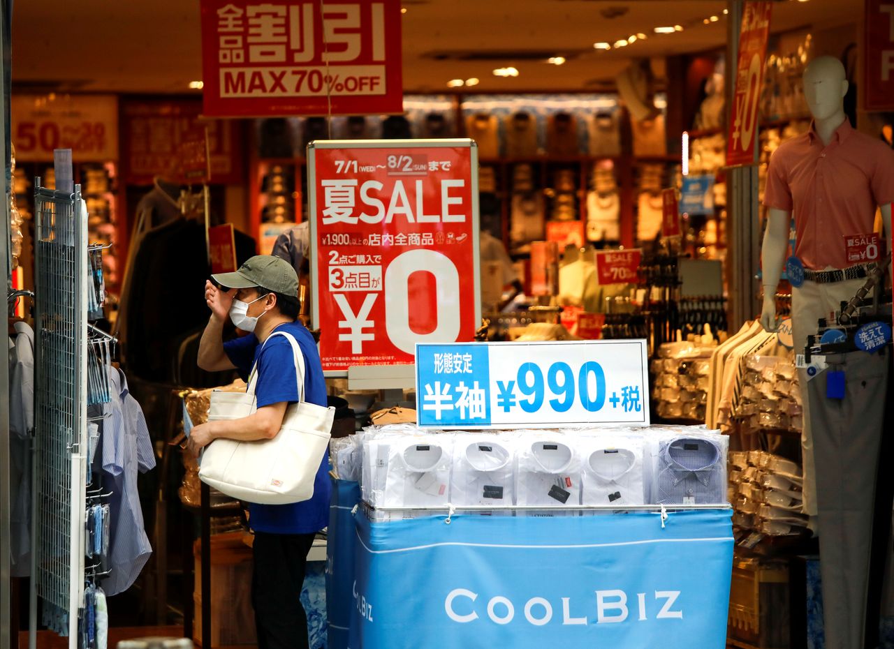 A shopper wearing a protective face mask is seen at a shop selling office wear, amid the coronavirus disease (COVID-19) outbreak in Tokyo, Japan July 27, 2020. REUTERS/Issei Kato/Files