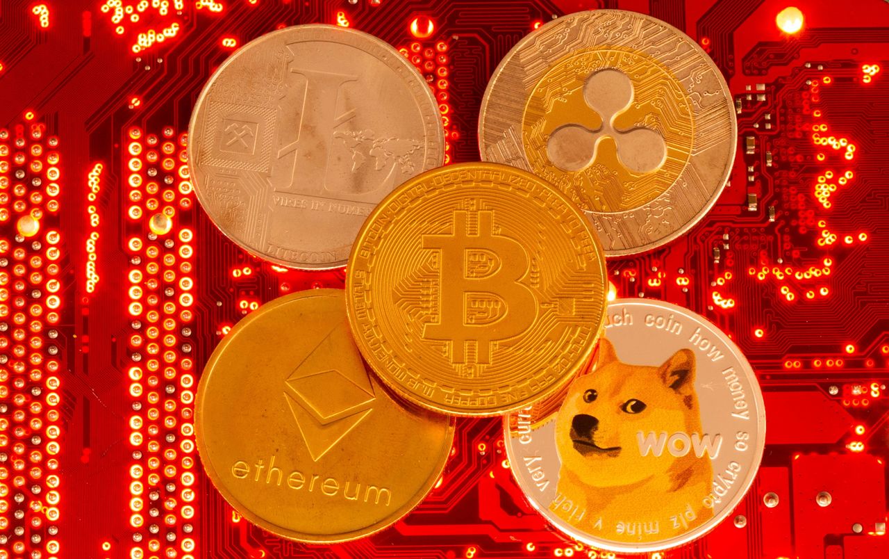 FILE PHOTO: Representations of cryptocurrencies Bitcoin, Ethereum, DogeCoin, Ripple, Litecoin are placed on PC motherboard in this illustration taken June 29, 2021. REUTERS/Dado Ruvic/Illustration