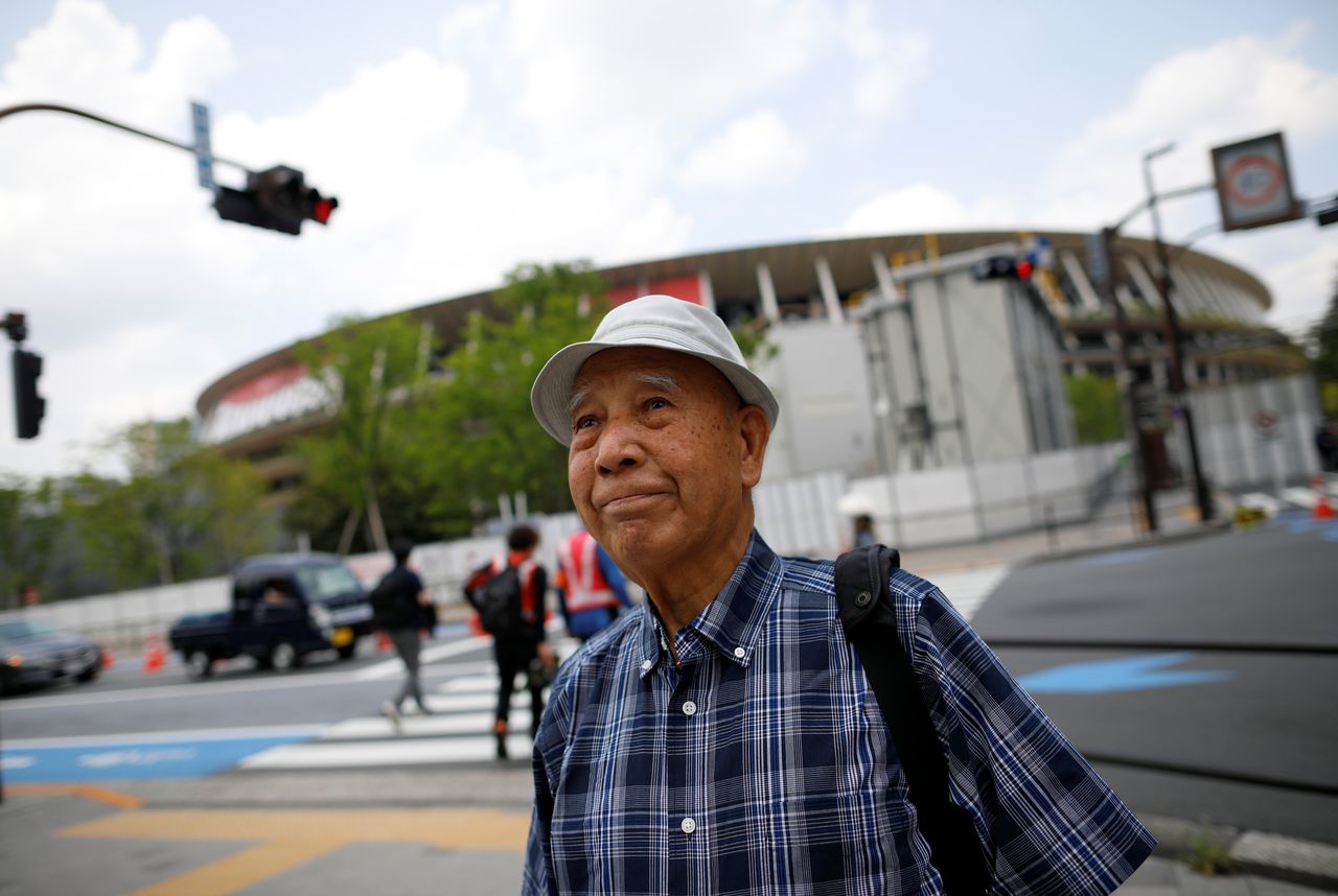 Kohei Jinno, 87, who was forced to leave his house two times ahead of the 1964 and 2020 Olympics Games to make way for construction of the main stadium, walks near the National Stadium, the main stadium for the 2020 Tokyo Olympic Games that have been postponed to 2021 due to the coronavirus disease (COVID-19) pandemic, in Tokyo, Japan June 24, 2021. REUTERS/Issei Kato