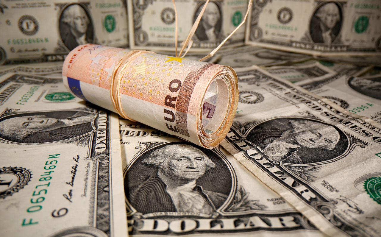 FILE PHOTO: Rolled Euro banknotes are placed on U.S. Dollar banknotes in this illustration taken May 26, 2020. REUTERS/Dado Ruvic/Illustration