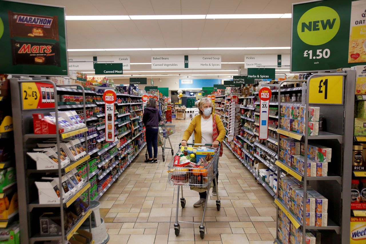 FILE PHOTO: A customer wearing a protective face mask shops at a Morrisons store in St Albans, Britain, September 10, 2020. REUTERS/Peter Cziborra/File Photo