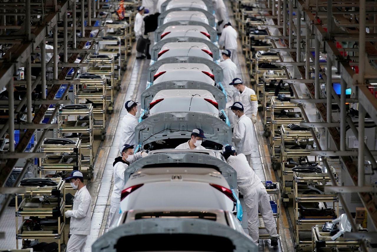 Employees work on a production line inside a Dongfeng Honda factory after lockdown measures in Wuhan, the capital of Hubei province and China