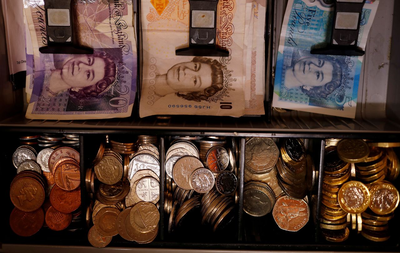 FILE PHOTO: Pound notes and coins are seen inside a cash register in a bar in Manchester, Britain September 6, 2017. REUTERS/Phil Noble//File Photo