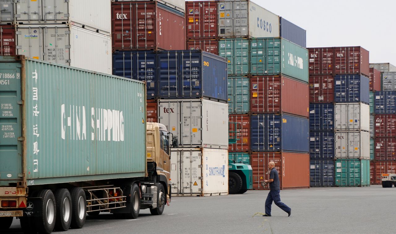 FILE PHOTO: A laborer works in a container area at a port in Tokyo, Japan July 19, 2017. REUTERS/Toru Hanai