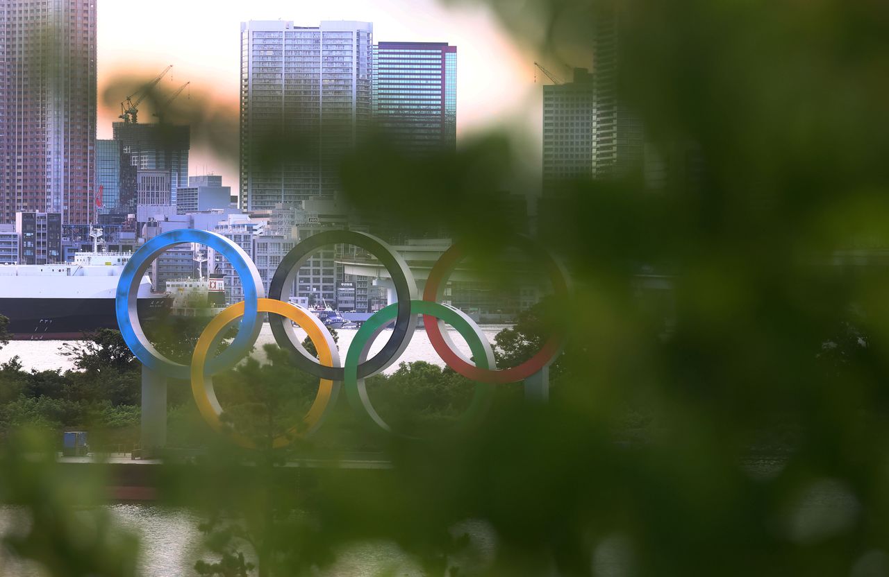 The Olympic Rings are seen in front of the skyline during sunset, three days ahead of the official opening of the Tokyo 2020 Olympic Games in Tokyo, Japan, July 20, 2021. REUTERS/Kai Pfaffenbach