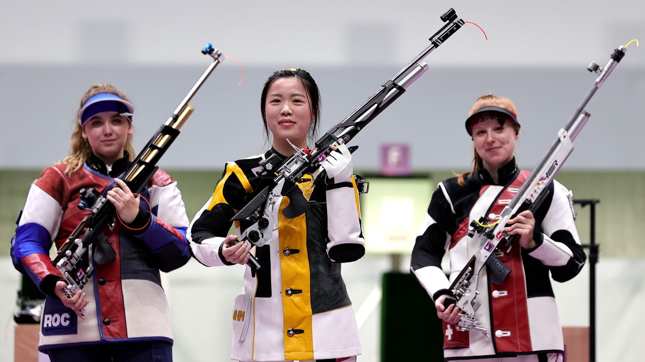 Tokyo 2020 Olympics - Shooting - Women's 10m Air Rifle - Final - Asaka Shooting Range, Tokyo, Japan – July 24, 2021. Gold medallist Yang Qian of China celebrates with silver medallist, Anastasiia Galashina of the Russian Olympic Committee and bronze medallist, Nina Christen of Switzerland REUTERS/Ann Wang