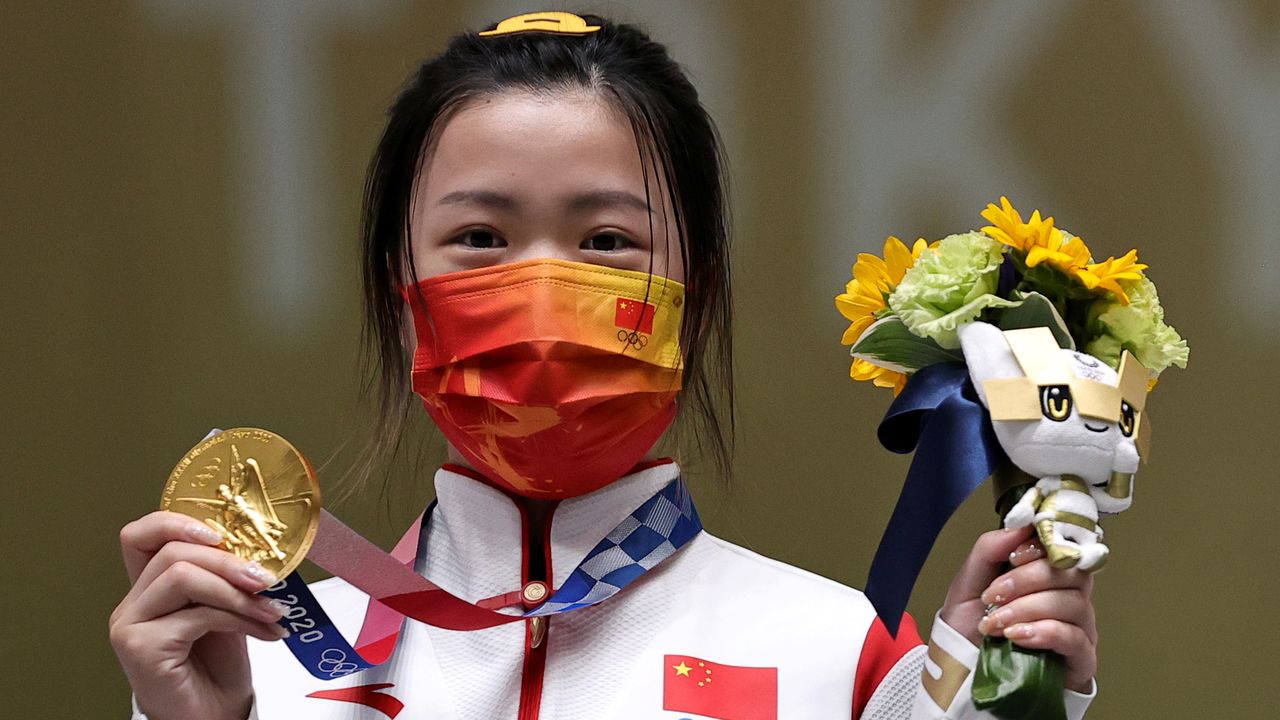 Tokyo 2020 Olympics - Shooting - Women's 10m Air Rifle - Medal Ceremony - Asaka Shooting Range, Tokyo, Japan – July 24, 2021. Gold medallist Yang Qian of China celebrates on the podium REUTERS/Ann Wang