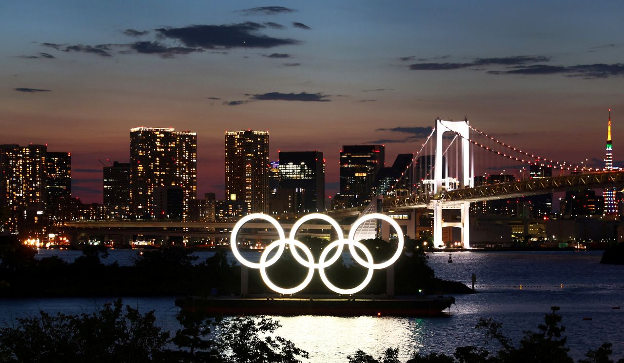 The Olympic Rings are seen in front of the skyline during sunset one night ahead of the official opening of the Tokyo 2020 Olympic Games in Tokyo, Japan, July 22, 2021. REUTERS/Kai Pfaffenbach