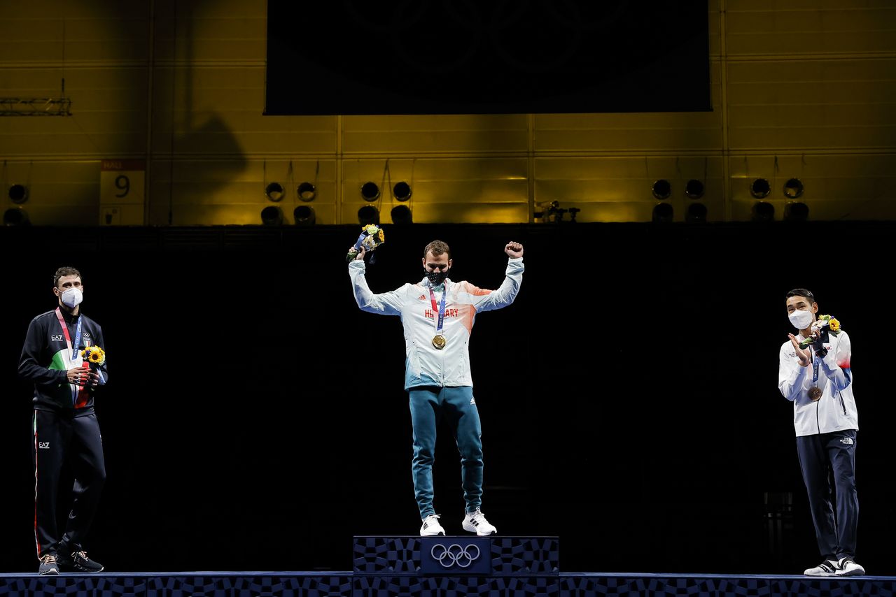 Tokyo 2020 Olympics - Fencing - Men's Individual Sabre - Medal Ceremony - Makuhari Messe Hall B - Chiba, Japan - July 24, 2021. Gold medallist Aron Szilagyi of Hungary celebrates on the podium with silver medallist, Luigi Samele of Italy and bronze medallist, Kim Jung-Hwan of South Korea REUTERS/Maxim Shemetov