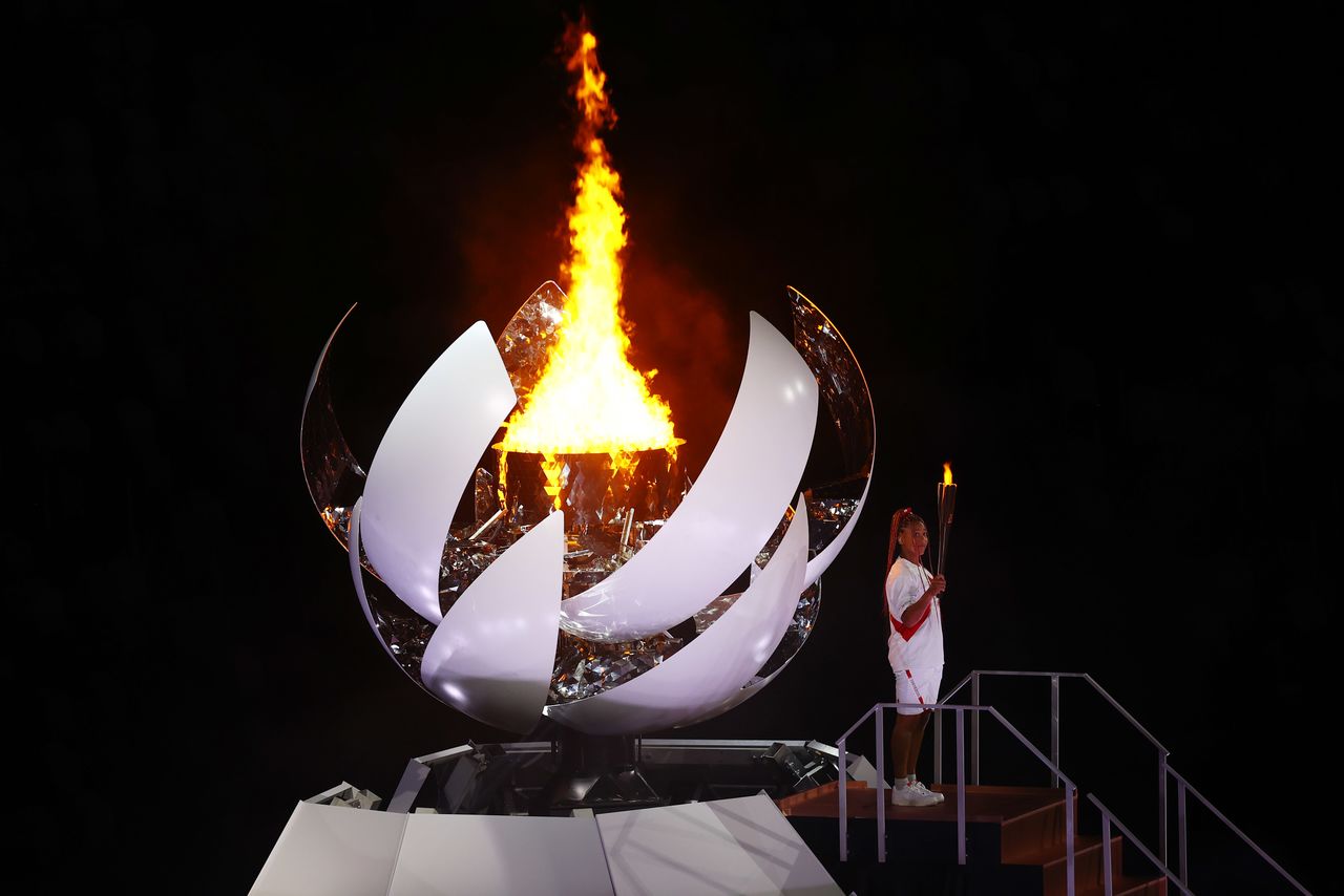 Tokyo 2020 Olympics - The Tokyo 2020 Olympics Opening Ceremony - Olympic Stadium, Tokyo, Japan - July 23, 2021. Naomi Osaka of Japan holds the Olympic torch after lighting the Olympic cauldron at the opening ceremony REUTERS/Mike Blake