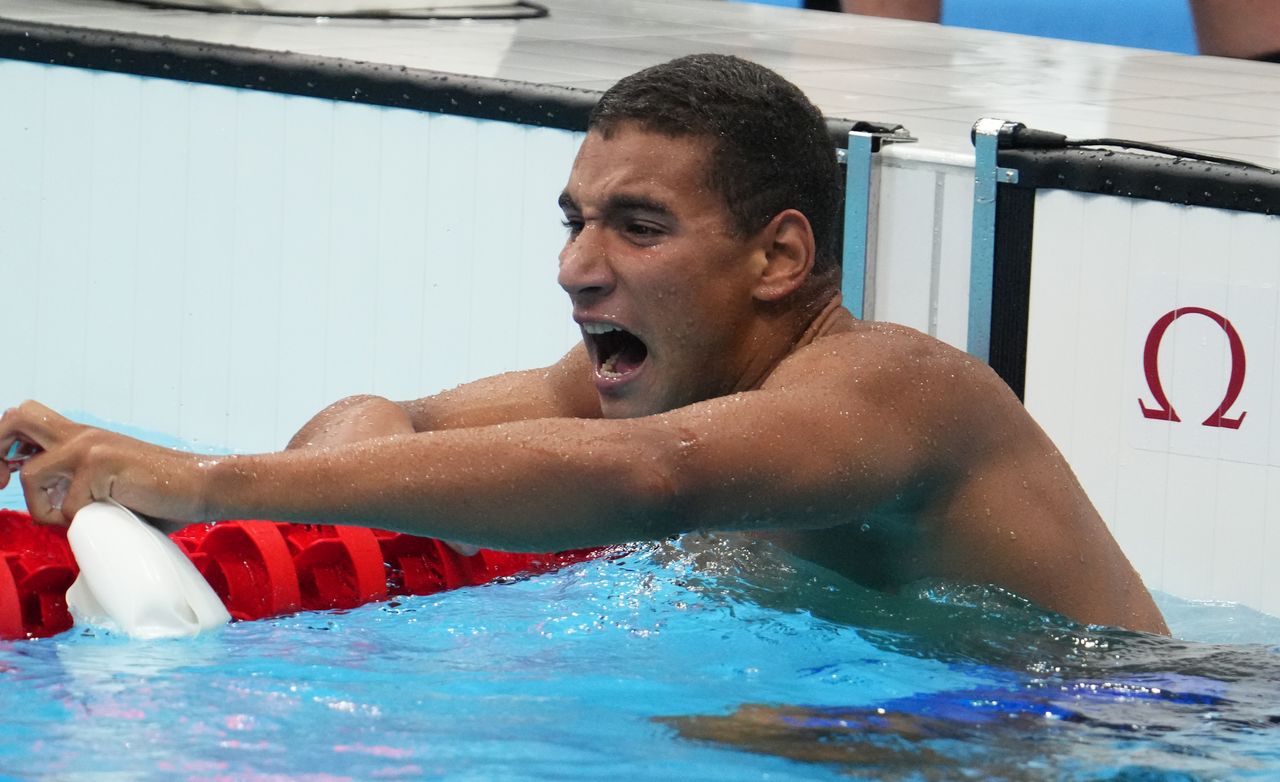 Jul 25, 2021; Tokyo, Japan; Ahmed Hafnaoui (TUN) celebrates after winning the men's 400m freestyle final during the Tokyo 2020 Olympic Summer Games at Tokyo Aquatics Centre. Mandatory Credit: Robert Hanashiro-USA TODAY Network