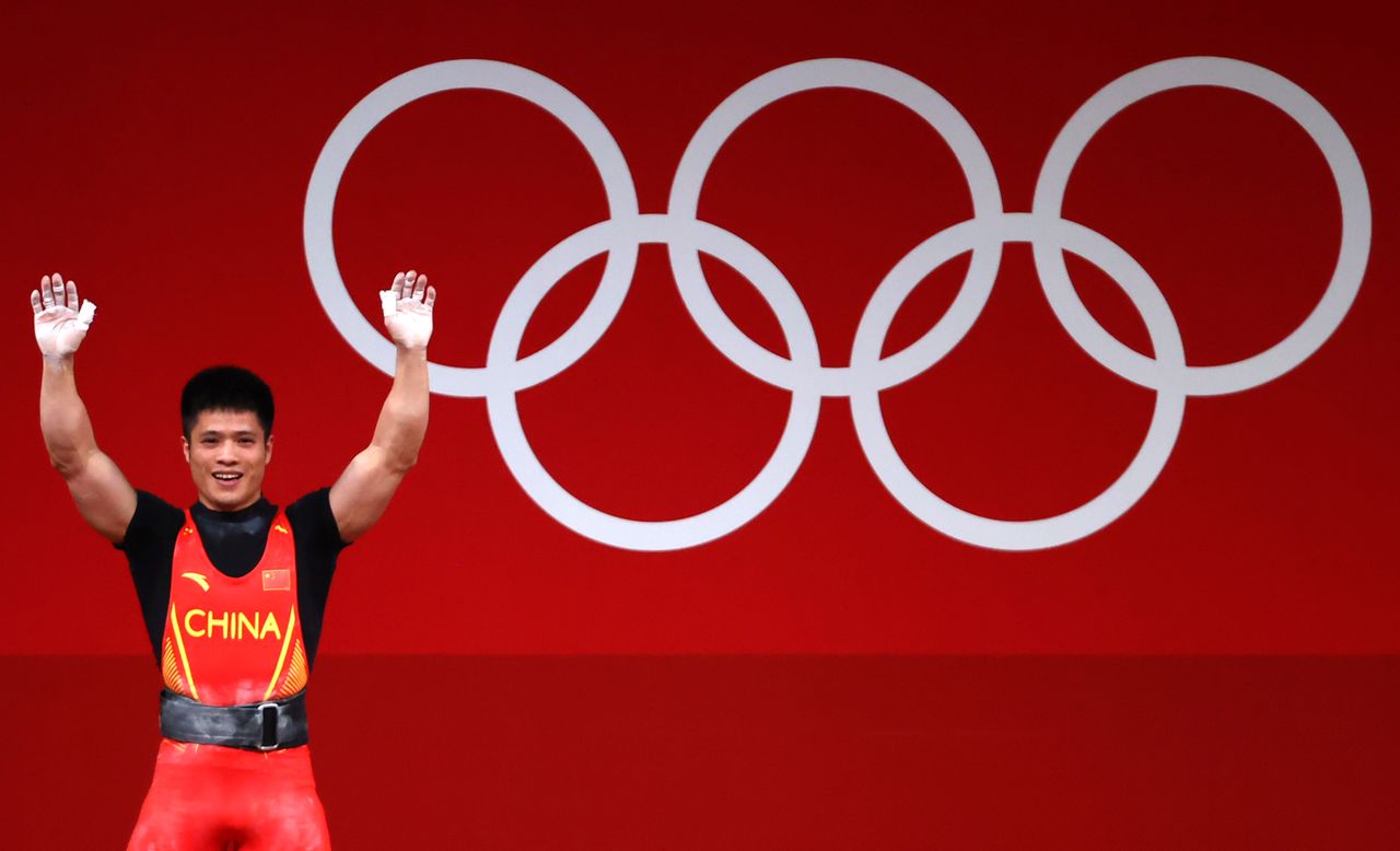 Tokyo 2020 Olympics - Weightlifting - Men's 61kg - Group A - Tokyo International Forum, Tokyo, Japan - July 25, 2021. Li Fabin of China reacts. REUTERS/Edgard Garrido