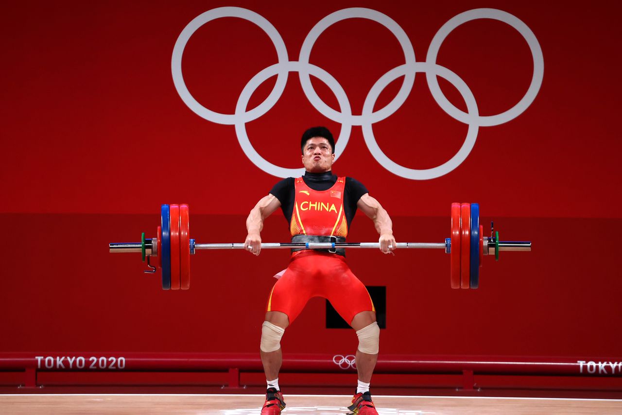 Tokyo 2020 Olympics - Weightlifting - Men's 61kg - Group A - Tokyo International Forum, Tokyo, Japan - July 25, 2021. Li Fabin of China in action. REUTERS/Edgard Garrido