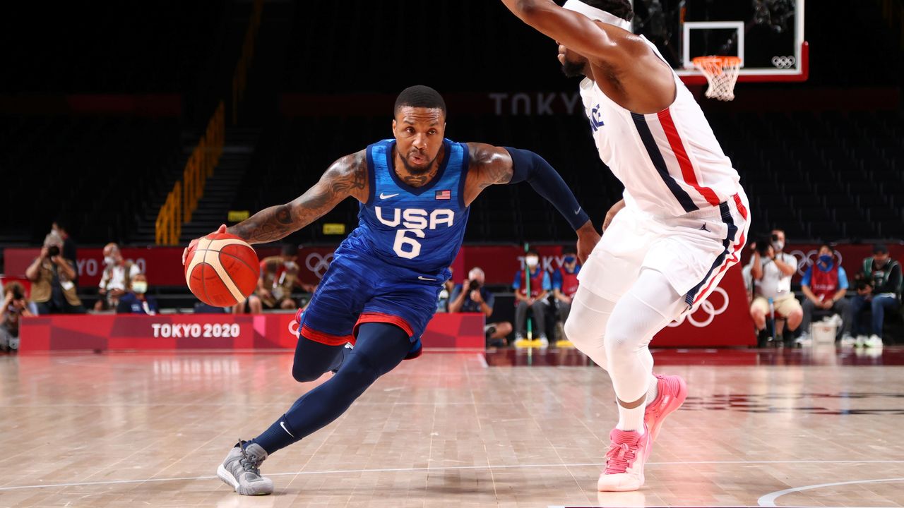 Tokyo 2020 Olympics - Basketball - Men - Group A - France v United States - Saitama Super Arena, Saitama, Japan - July 25, 2021. Damian Lillard of the United States in action with Guerschon Yabusele of France REUTERS/Brian Snyder