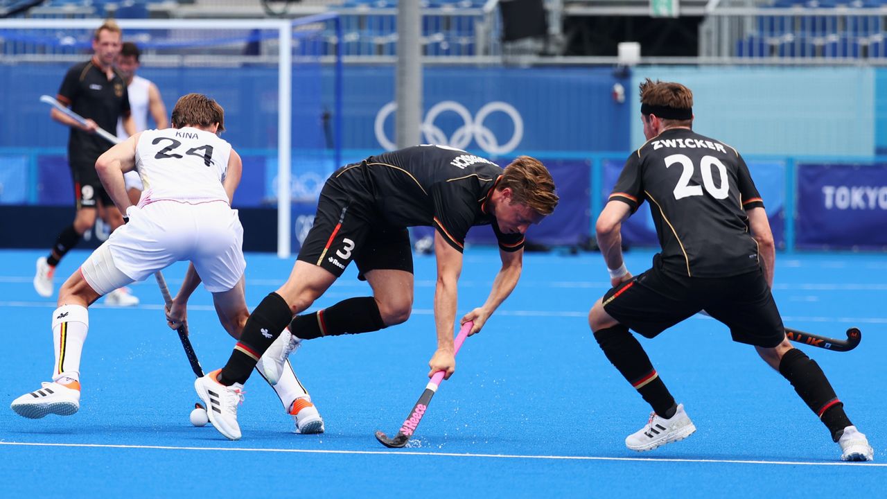Tokyo 2020 Olympics - Hockey - Men's Pool B - Germany v Belgium - Oi Hockey Stadium, Tokyo, Japan - July 26, 2021. Mats Grambusch of Germany and Martin Zwicker of Germany in action against Antoine Kina of Belgium. REUTERS/Bernadett Szabo